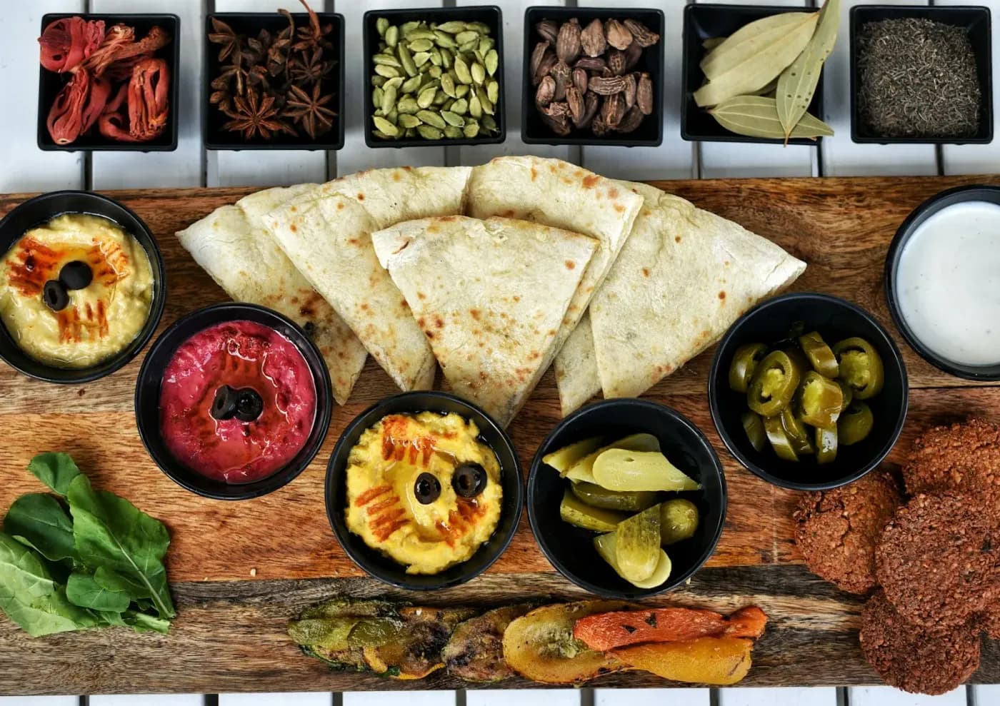 A spread of dishes laid out on a wooden table